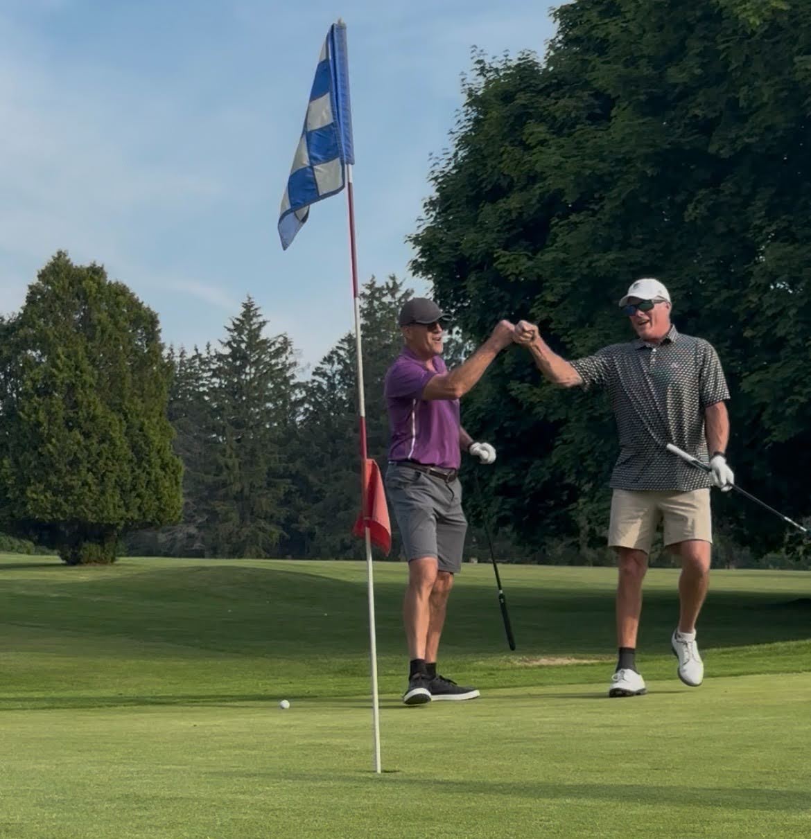 Brothers at a tee box during the TOAA golf tournament
